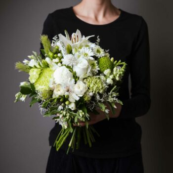 posy of fresh seasonal white and green flowers including roses snapdragons carnation disbud chrysanthemums freesia hypericum berries scabiosa tweedia and foliage