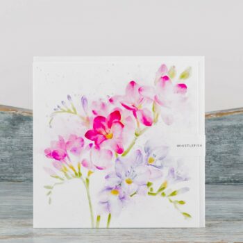 large greeting card with white envelope made by whistlefish cover depicts powder vibrant pink and light mauve freesias in watercolour on light lime green stems blank inside