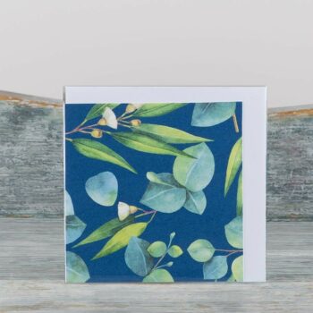 small greeting card with white envelope blue card with small green eucalyptus leaves printed on front blank inside
