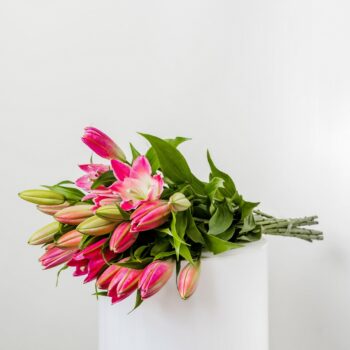 a bouquet of pink long stem perfumed semi open oriental lilliums