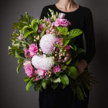 flowers pink with foliage arranged into a forward facing bouquet