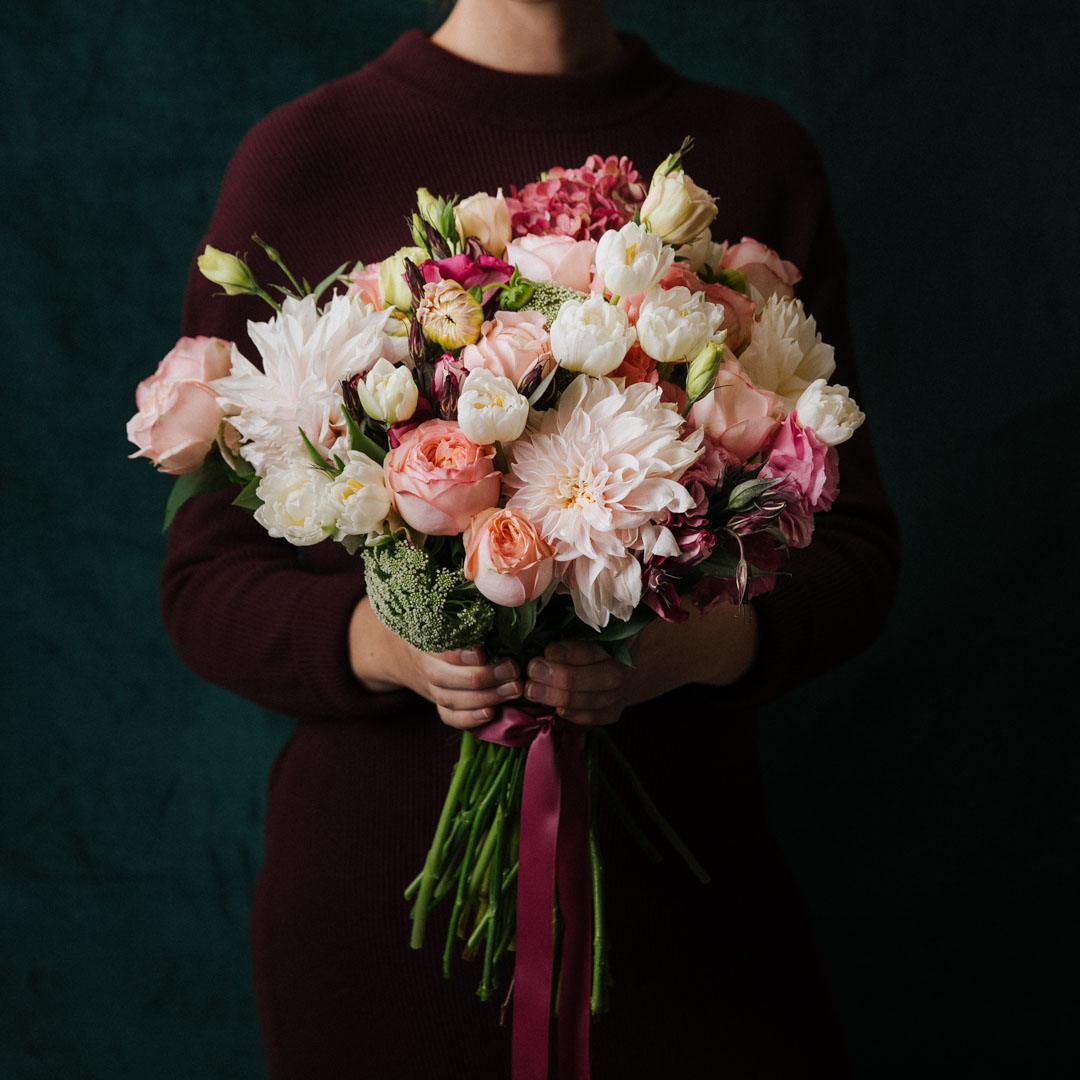 Large pink flowers bouquet made with seasonal flowers including dahlias tulips roses hydrangea and lisianthus