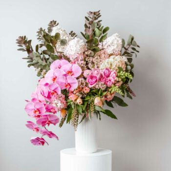 large vase of pink fresh flowers including roses tulips hydrangea snapdragons and phalaenopsis orchids
