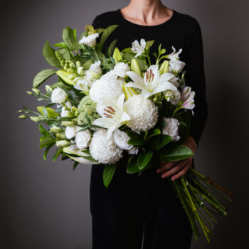 flowers white and green with foliage arranged into a forward facing bouquet